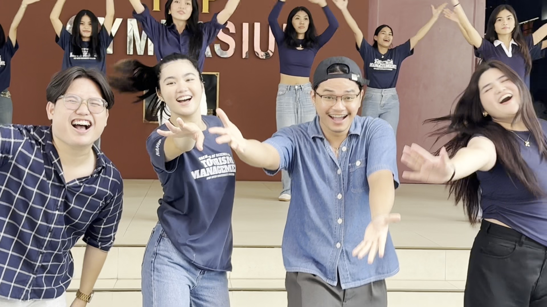 The Liwayway team smiling and performing together during creative production
