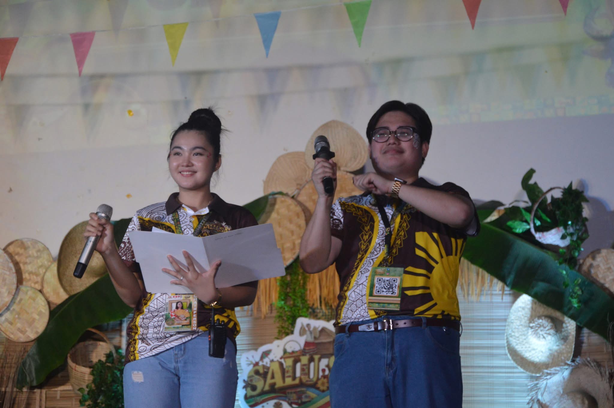 Two presenters holding microphones on the Salu-Salo stage